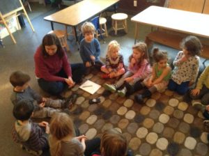 children in a group discussing Santa